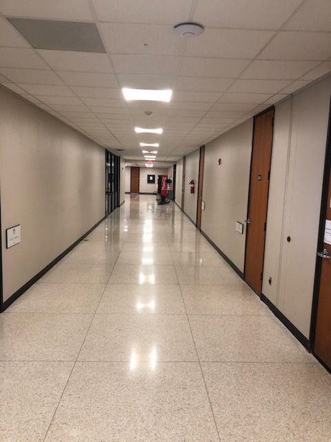 A long hallway with a fire extinguisher on the wall