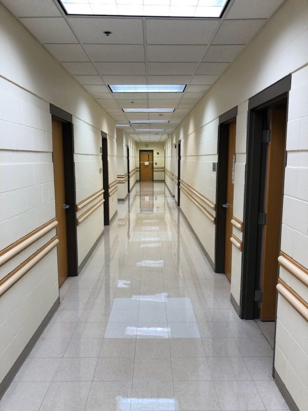 A long hallway with a door in the middle