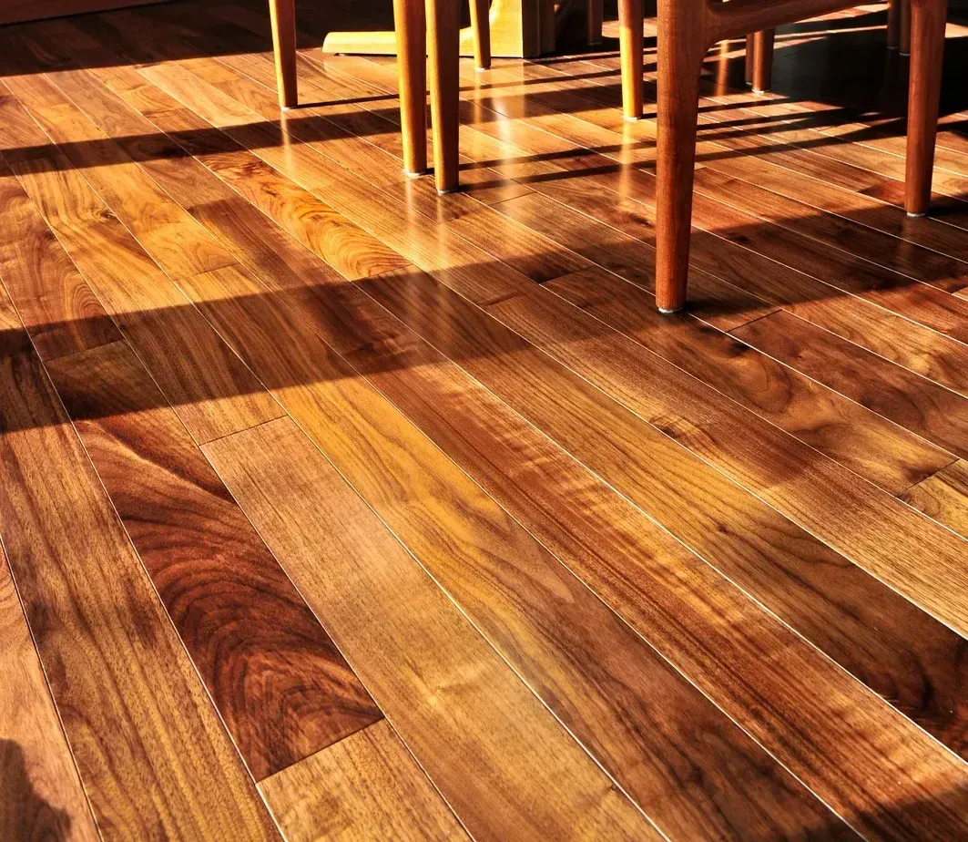 A hallway with hardwood floors and white trim in a house.