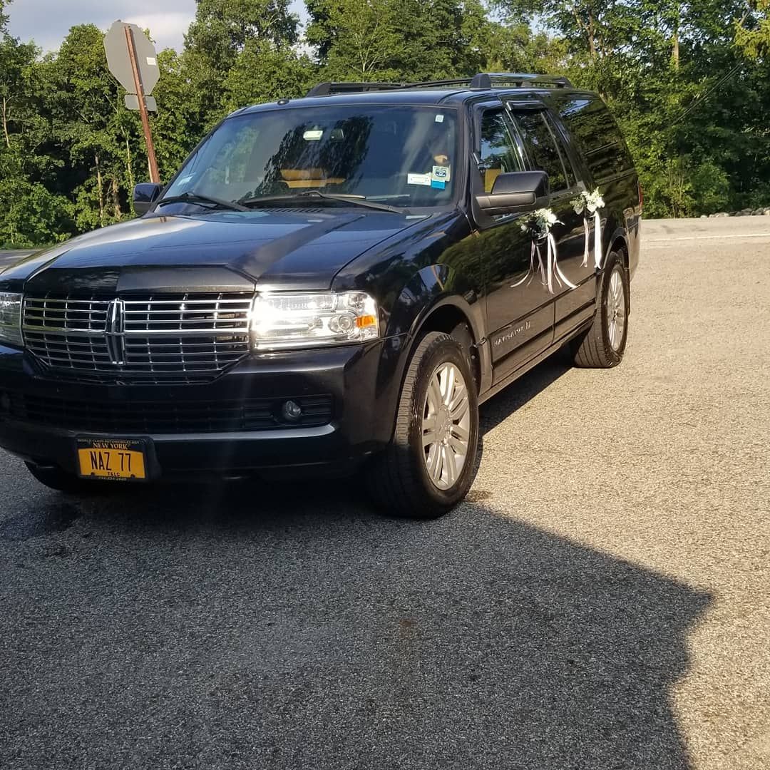 A black ford expedition is parked in a parking lot.