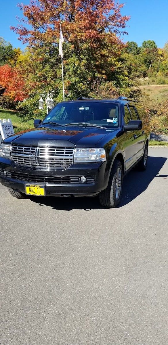 A black ford expedition is parked in a parking lot.