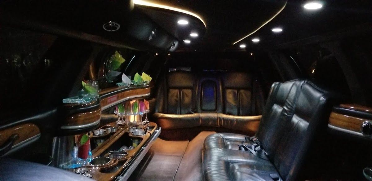The inside of a limousine with a bar in the back.