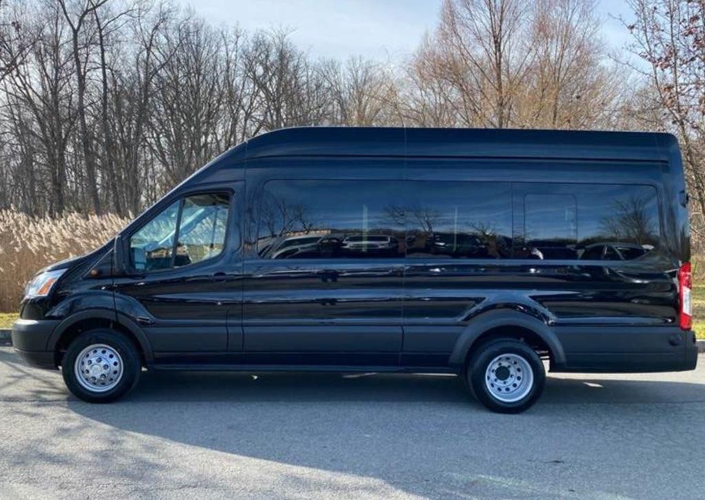 A black van is parked on the side of the road.