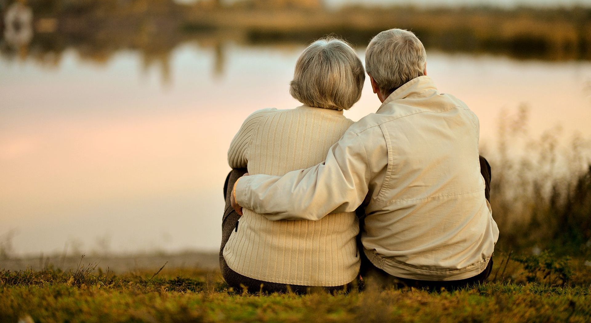 a man in a suit is comforting a woman at a funeral .