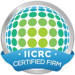 A circle with green dots and a blue ribbon that says iicrc certified firm