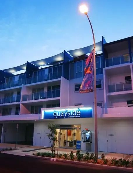 A Quayside Building Is Lit Up At Night — Greg Keft Electrical in Port Macquarie, NSW