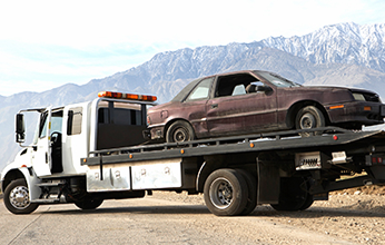 Tow truck carrying car - Emergency service towing in Oxnard, California