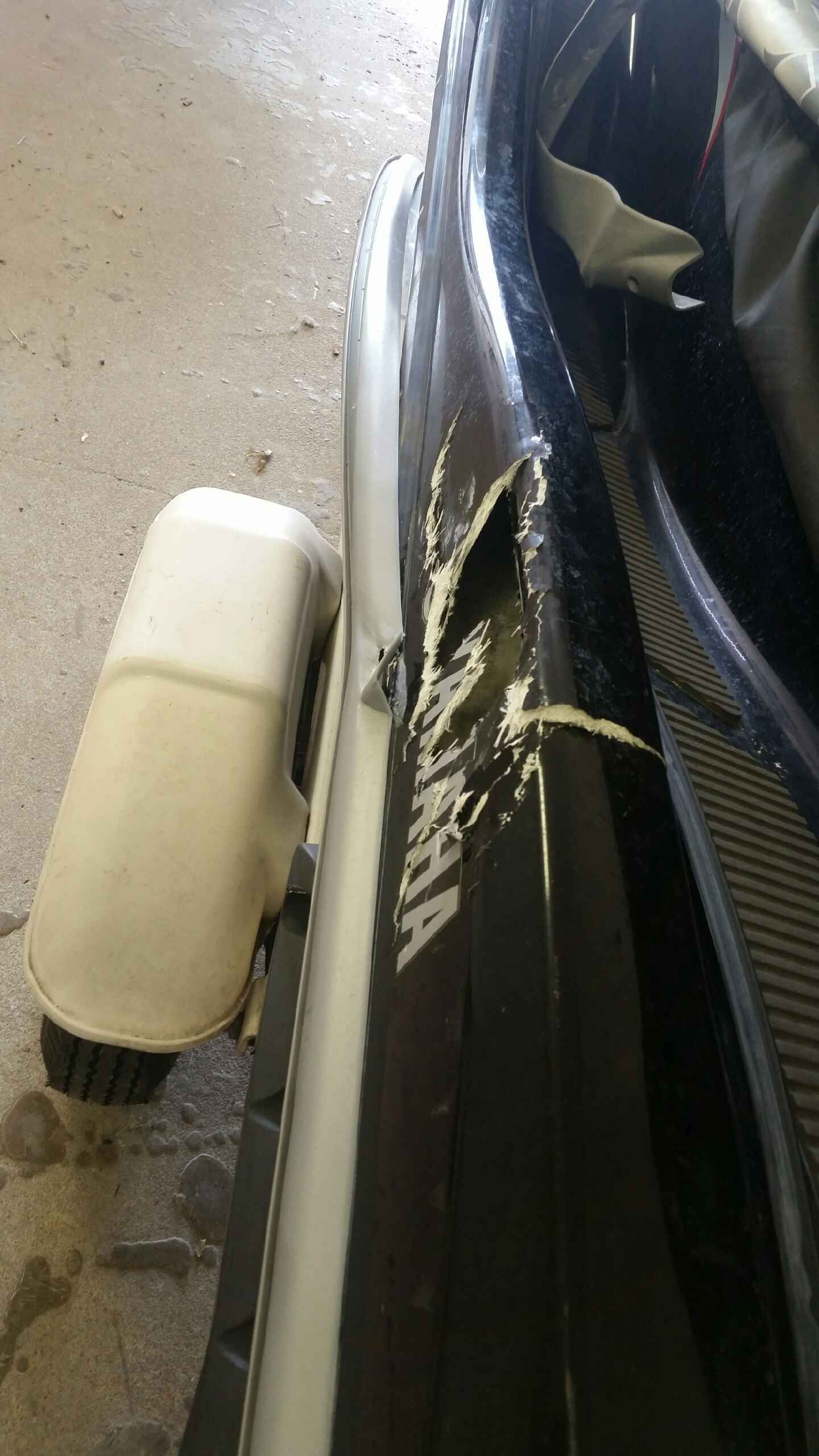 A red and white boat is parked on a trailer