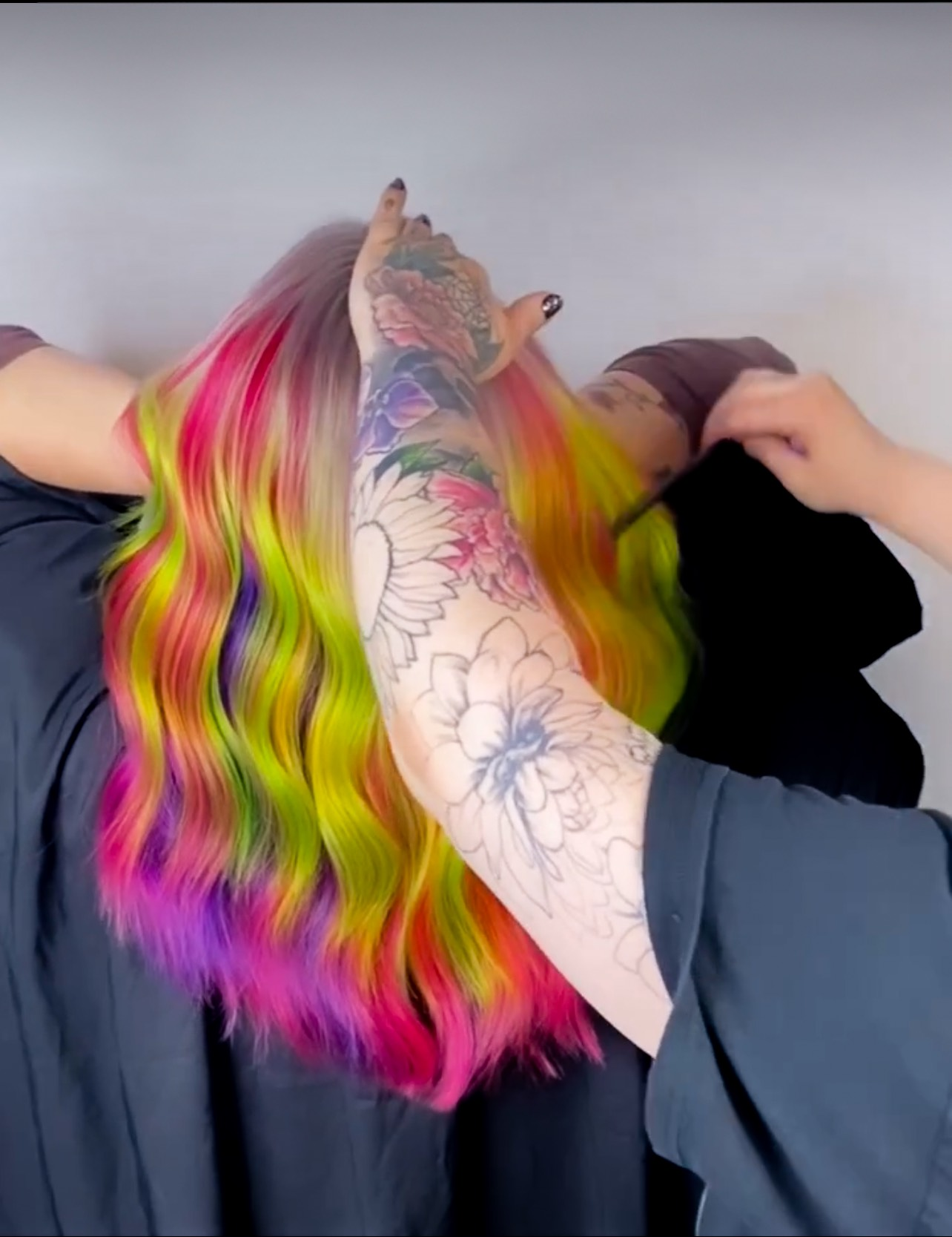 A woman is getting her hair dyed in a salon.