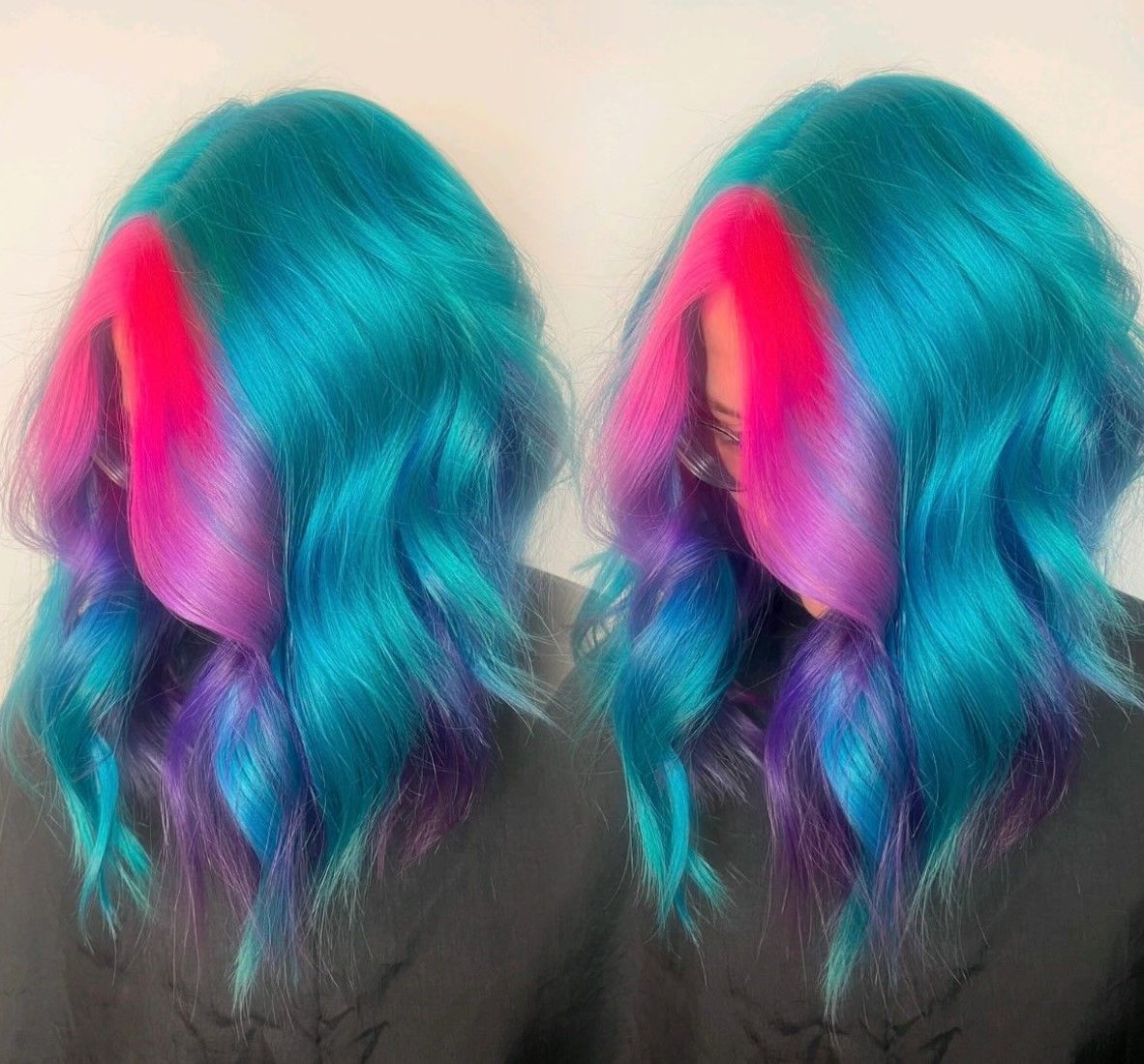 Two women with blue and purple hair are standing next to each other.