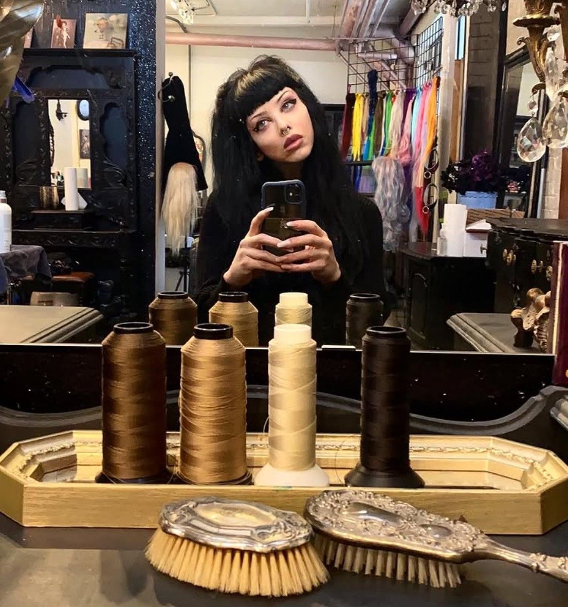 A woman is taking a picture of herself in a mirror