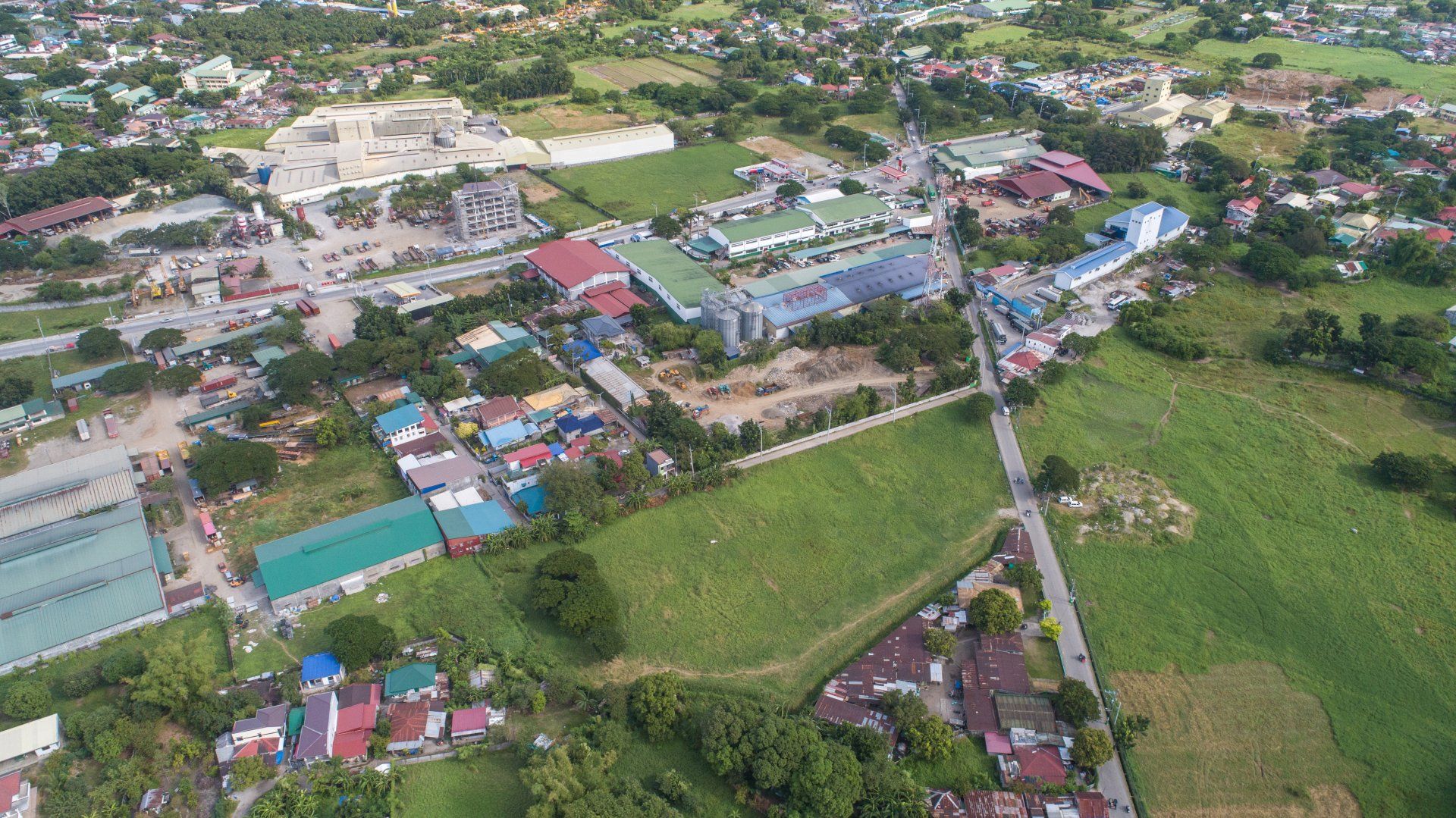 An aerial view of a city with lots of buildings and trees.