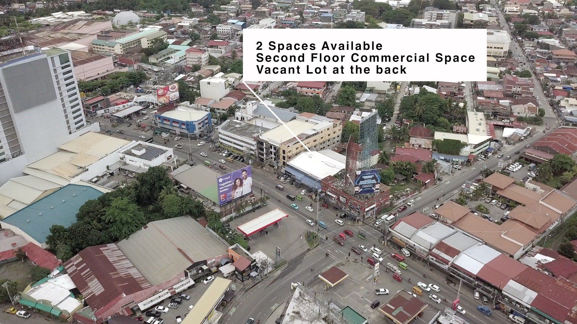 An aerial view of a city with a sign that says 3 spaces available