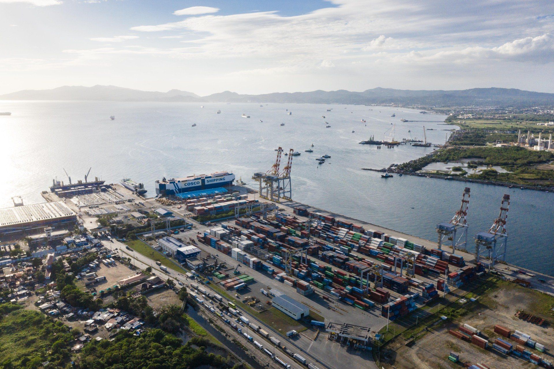 An aerial view of a harbor filled with lots of containers and ships.