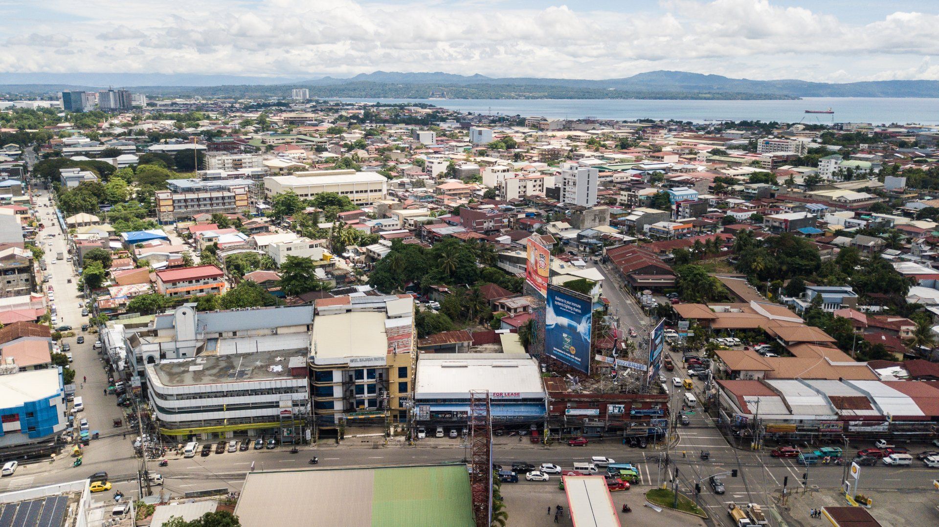 An aerial view of a city with a lake in the background.