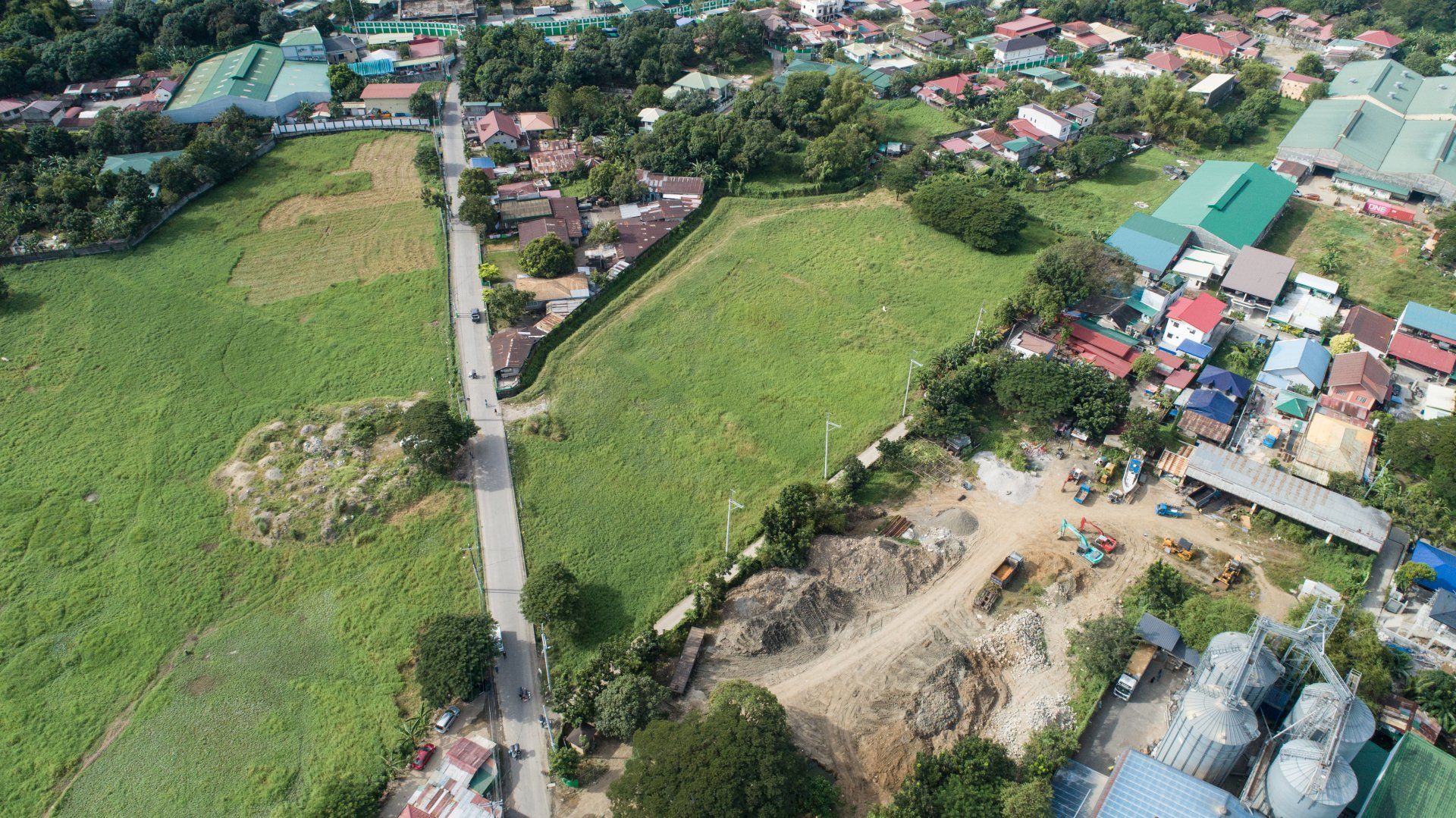 An aerial view of a residential area with a lot of buildings and a road.