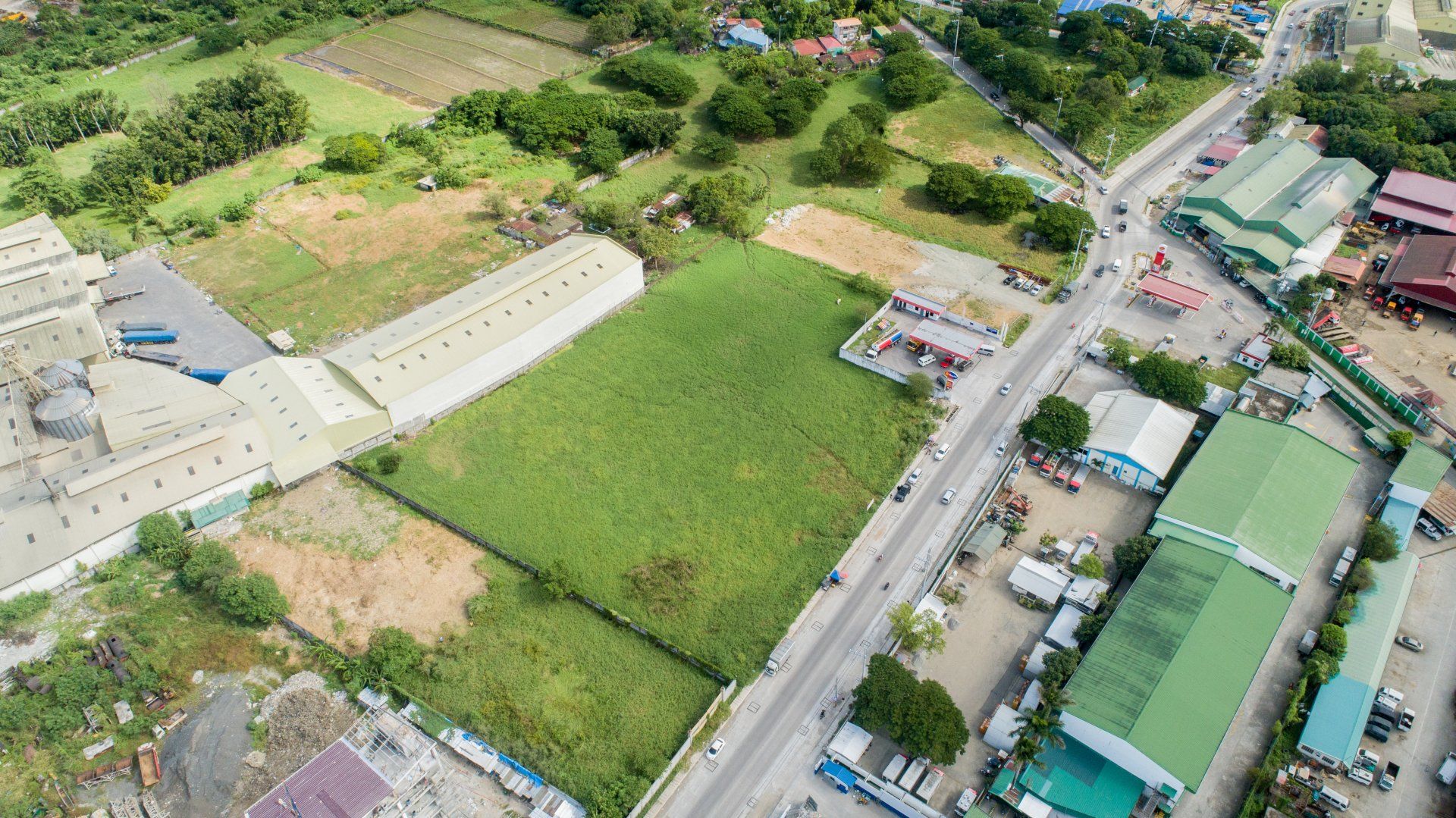 An aerial view of a city with lots of buildings and lots of trees.