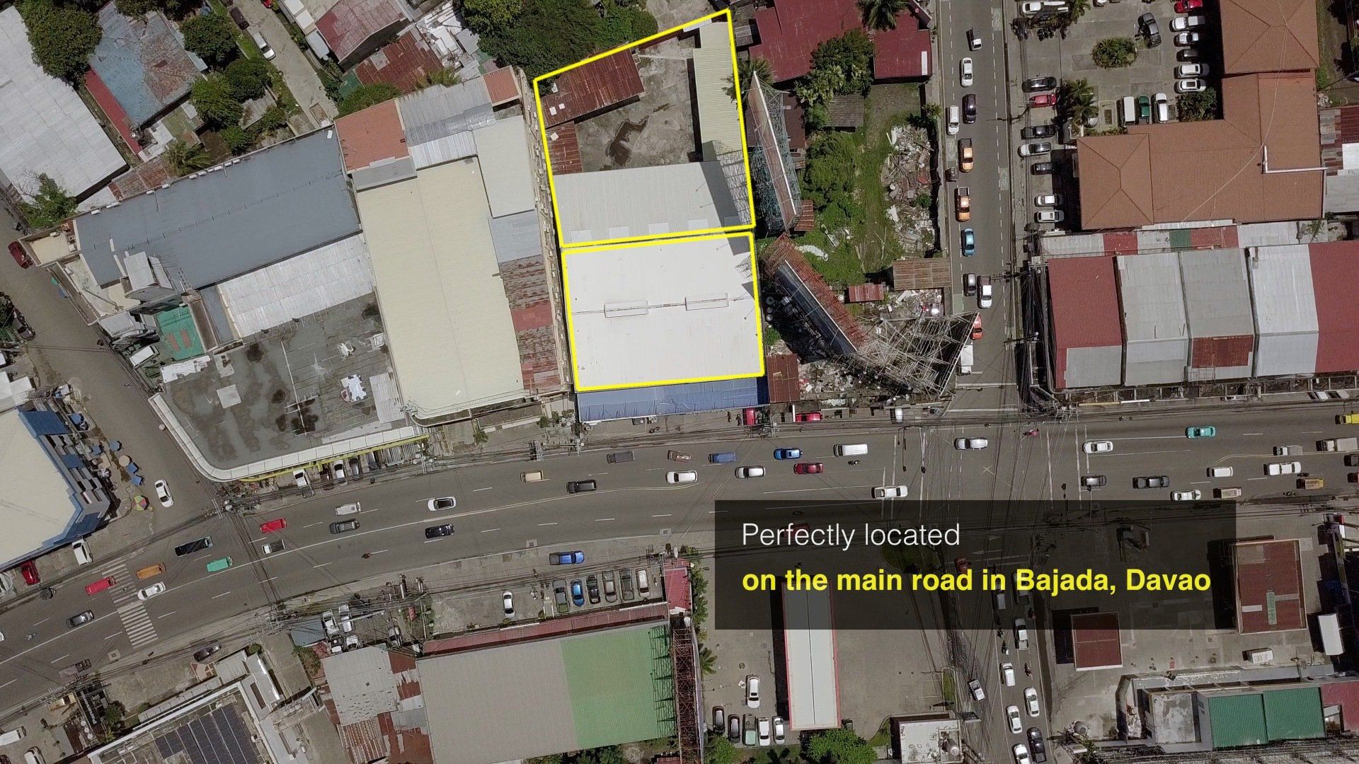 An aerial view of a city with a yellow square in the middle