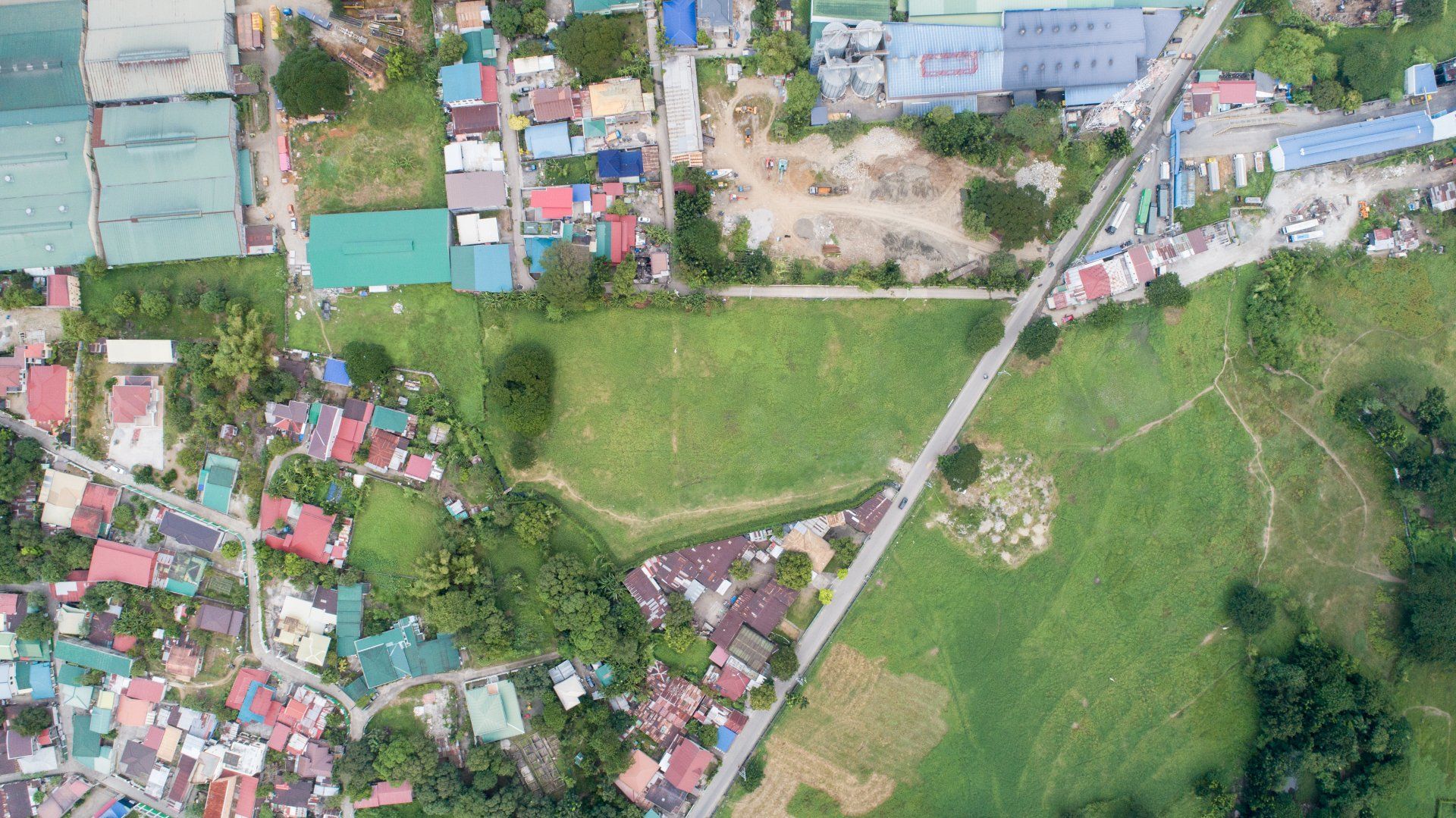 An aerial view of a residential area with lots of houses and trees.