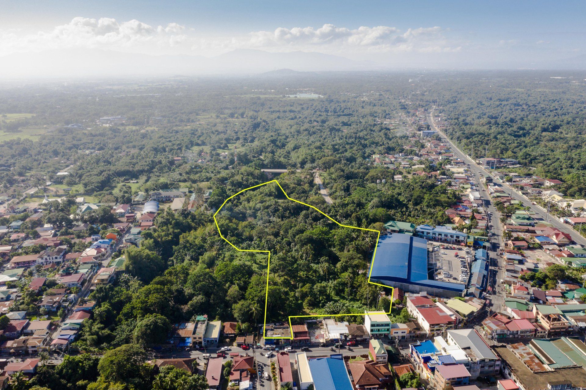 An aerial view of a city surrounded by trees and buildings
