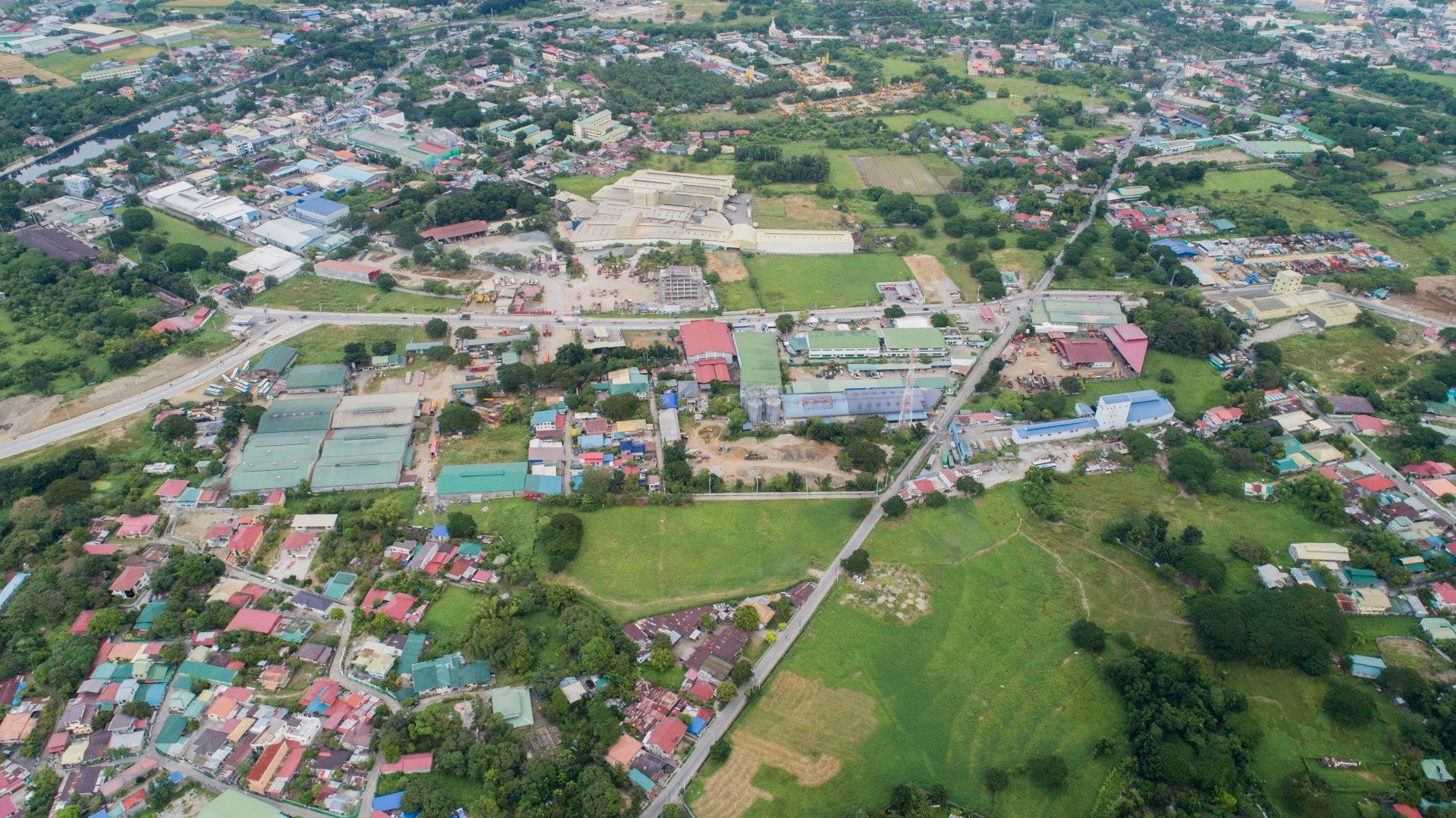 An aerial view of a small town with lots of houses and trees.