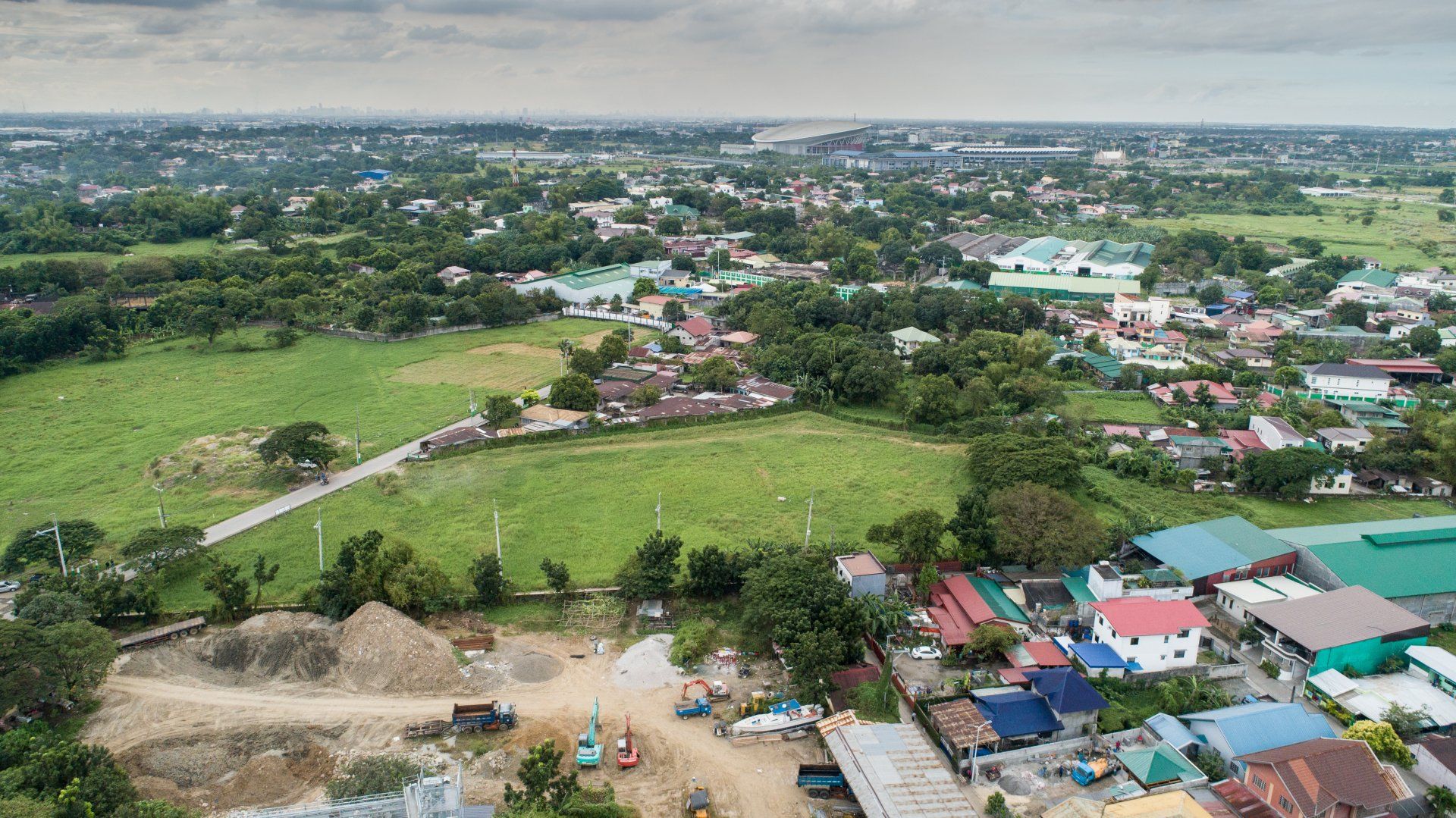 An aerial view of a small town with a lot of houses and a lot of grass.