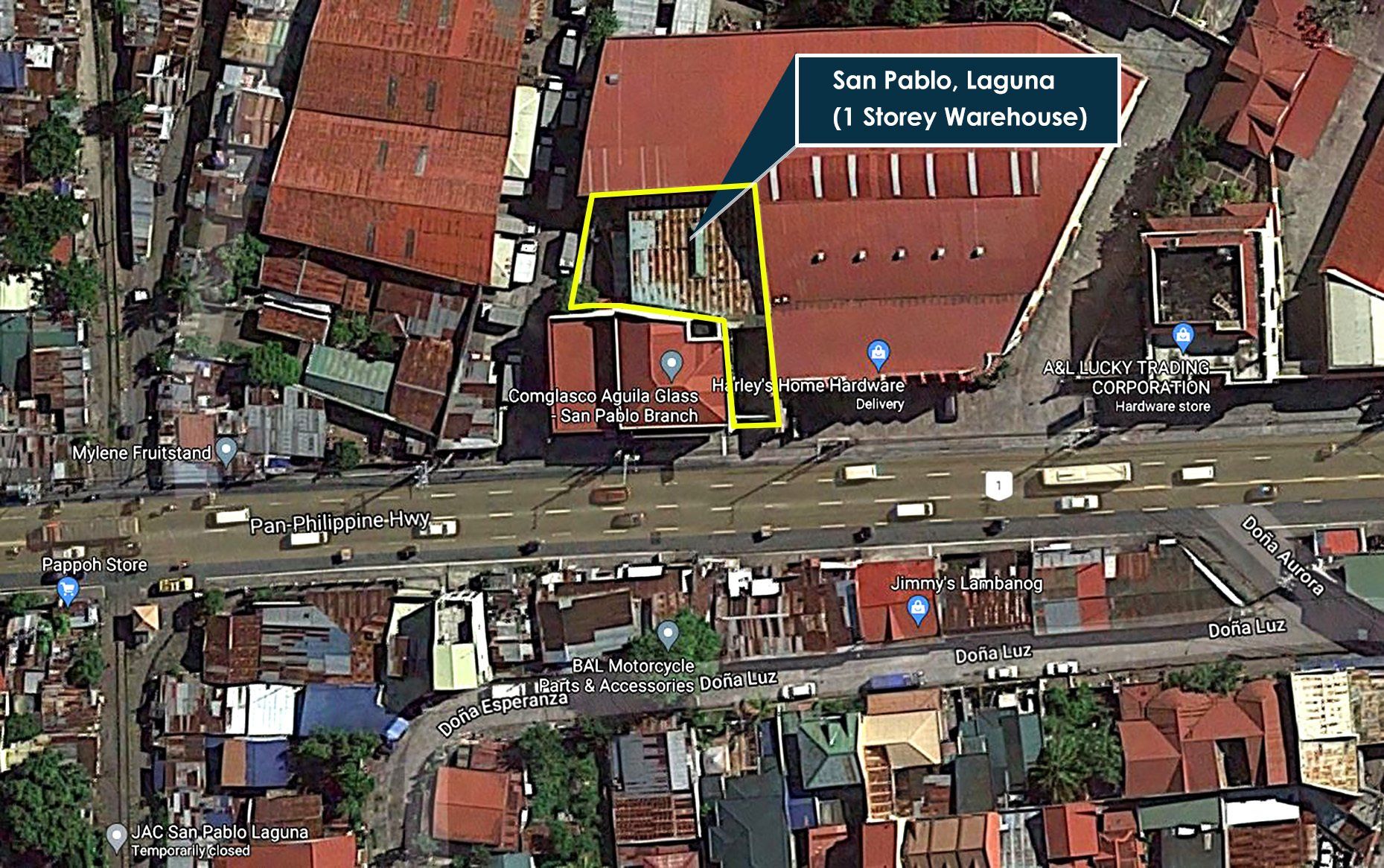 An aerial view of a city with a building in the middle