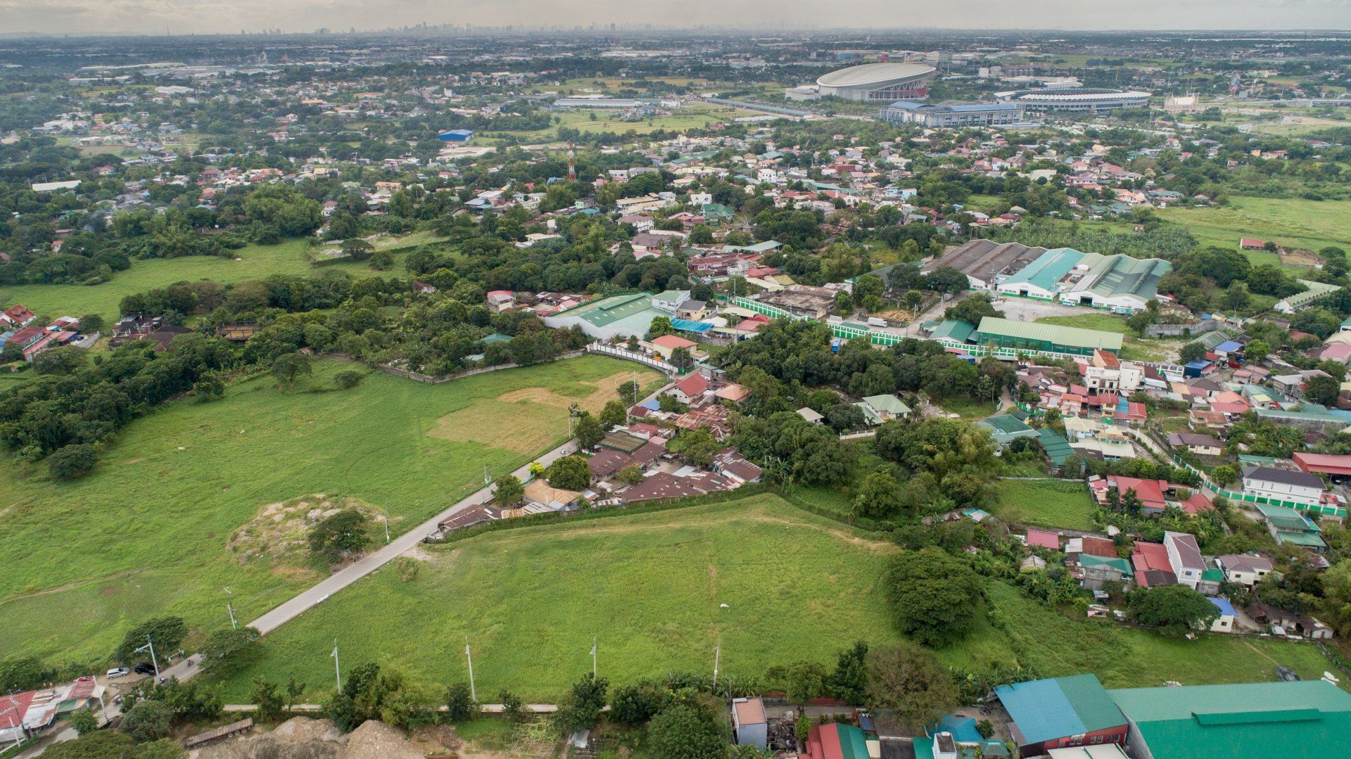 An aerial view of a small town surrounded by trees and buildings.