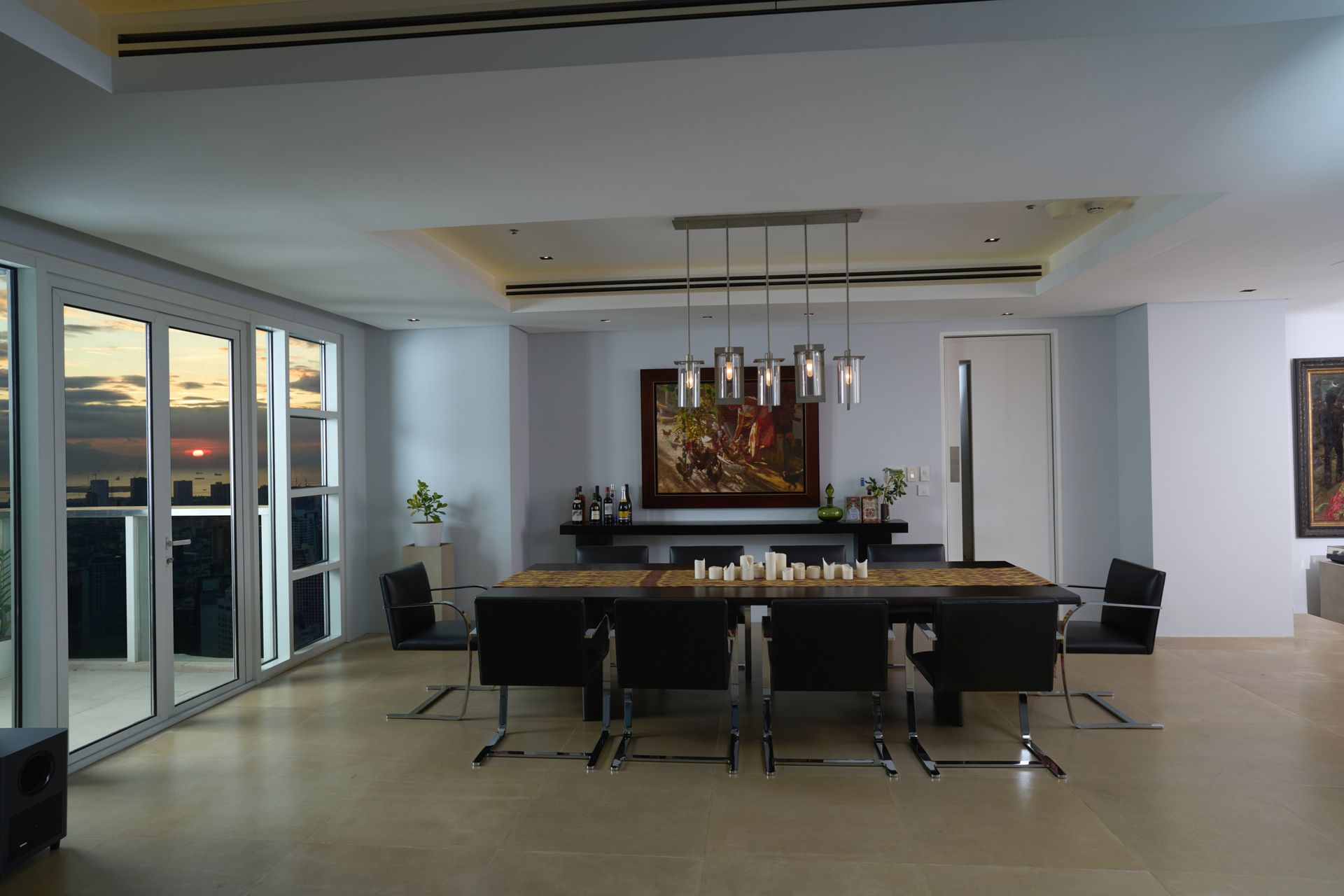 A dining room with a large table and chairs