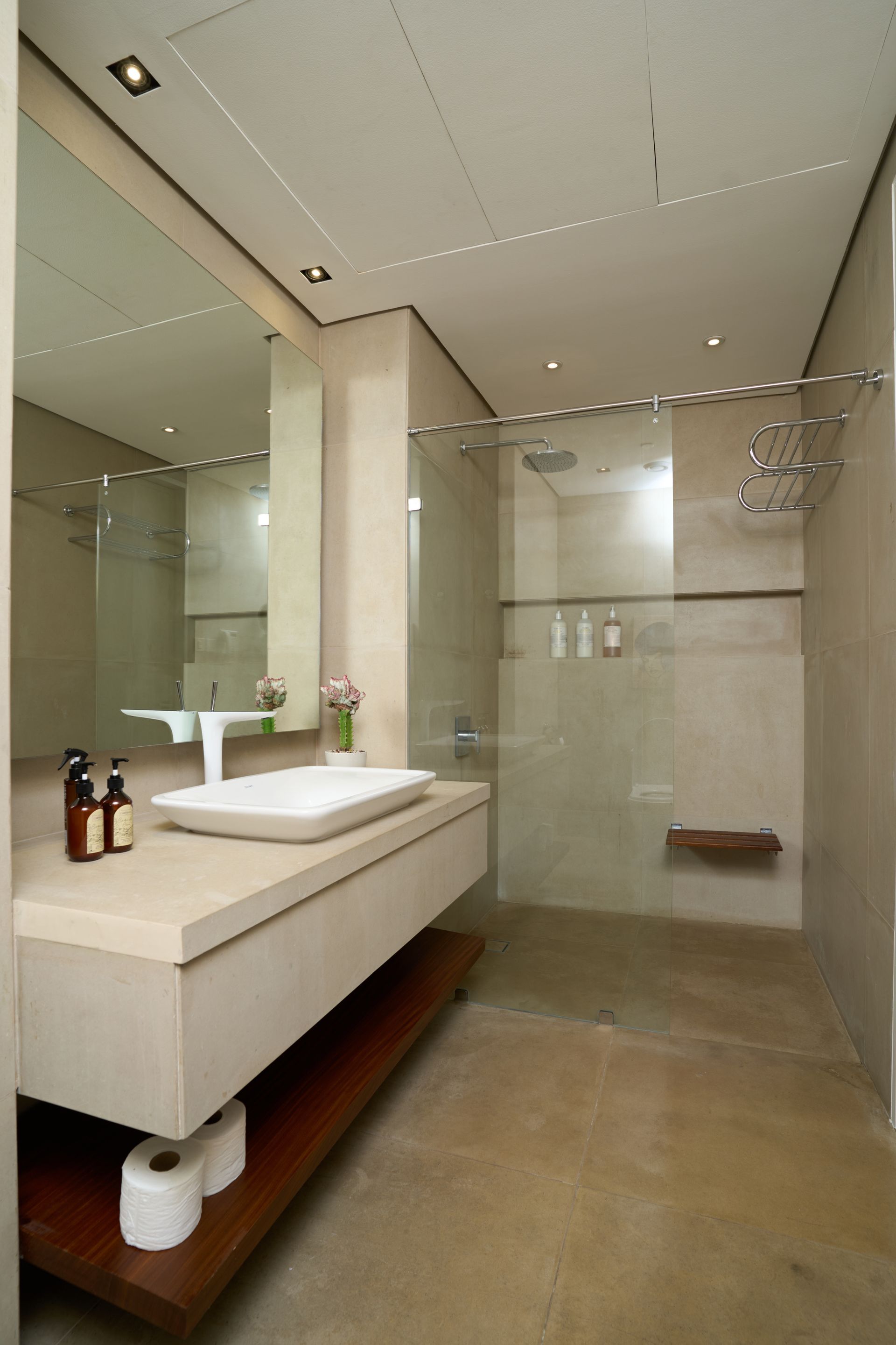 A bathroom with a sink a mirror and a walk in shower