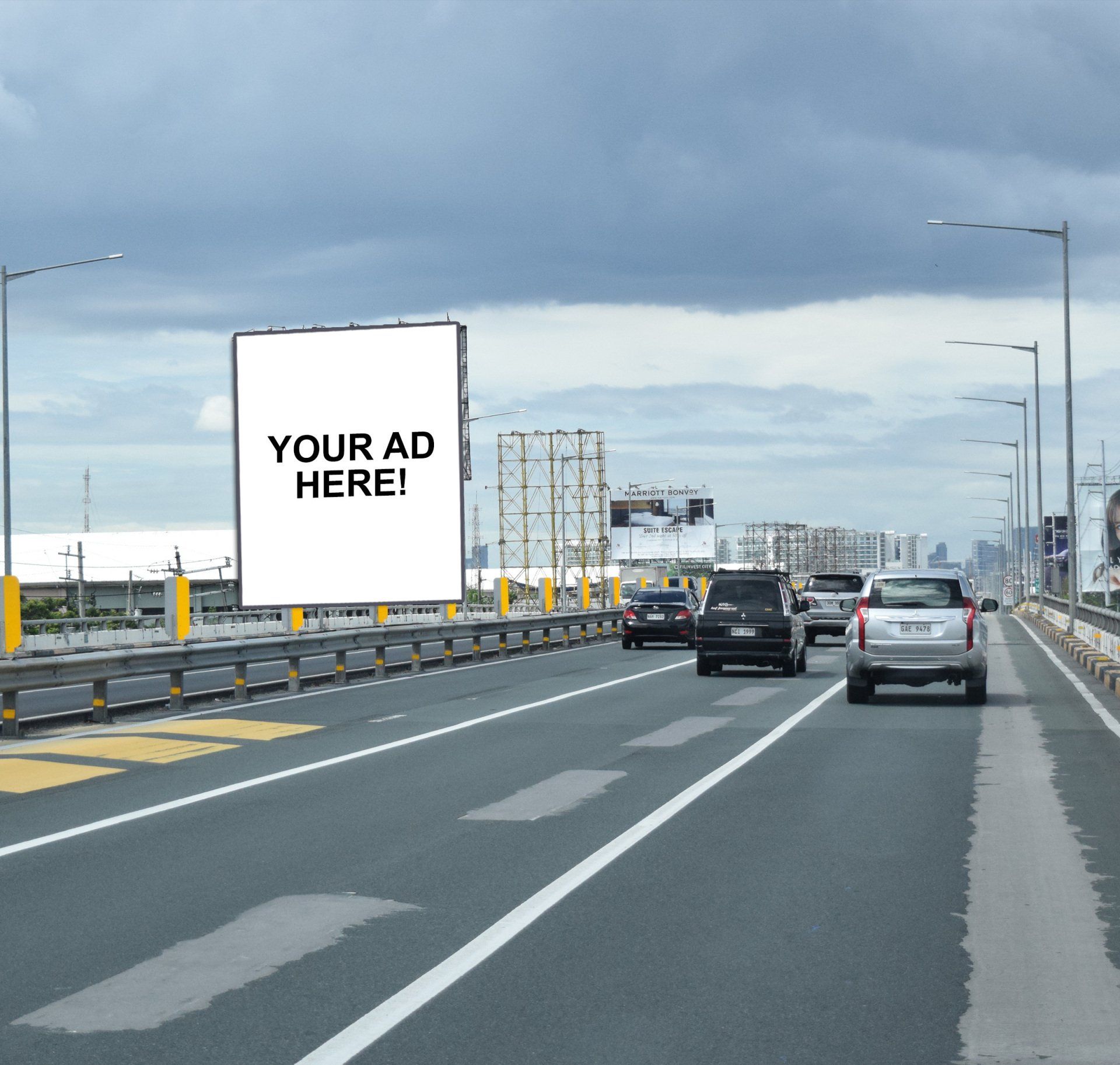 A billboard on the side of a highway says your ad here