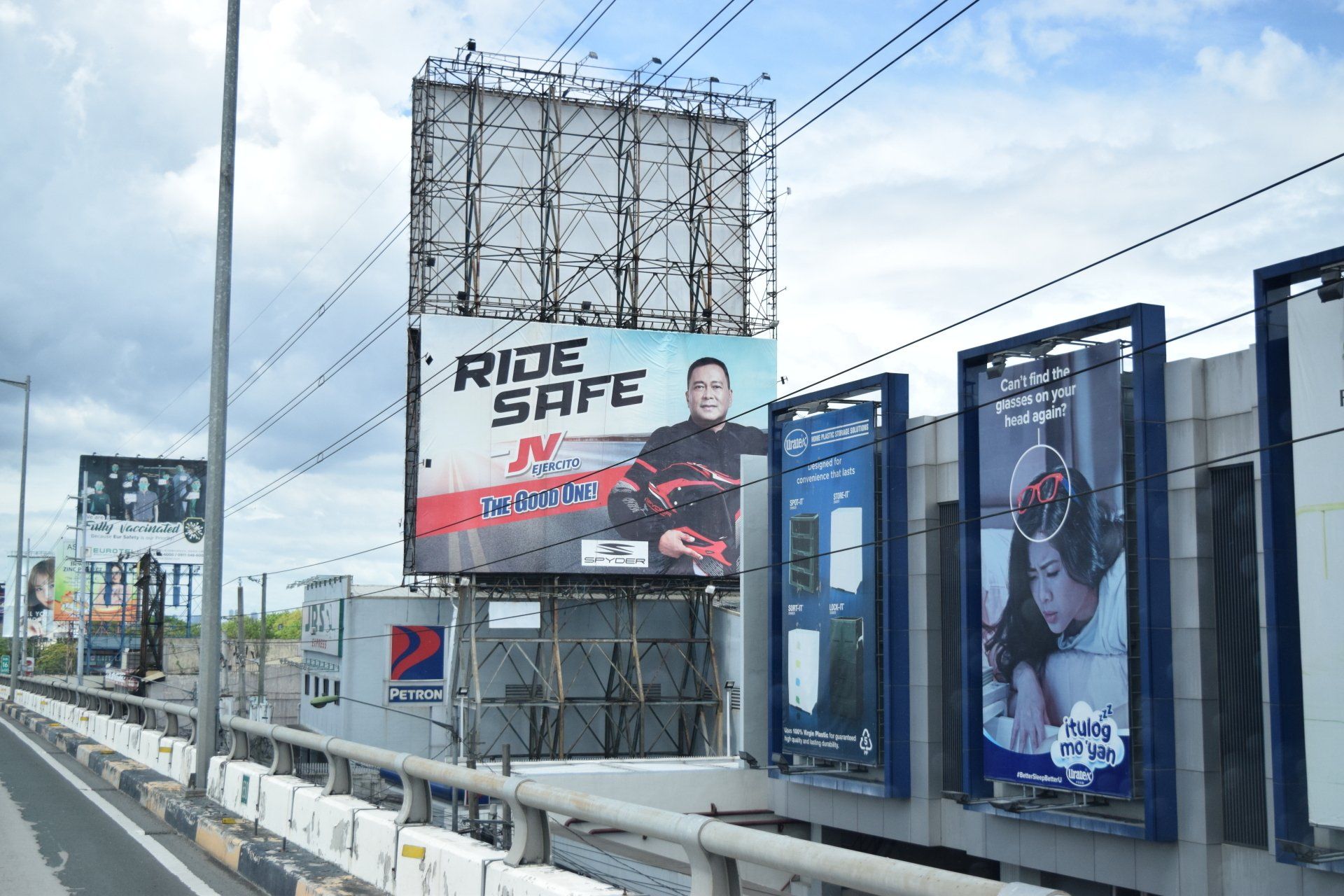A billboard on the side of a highway that says ride safe