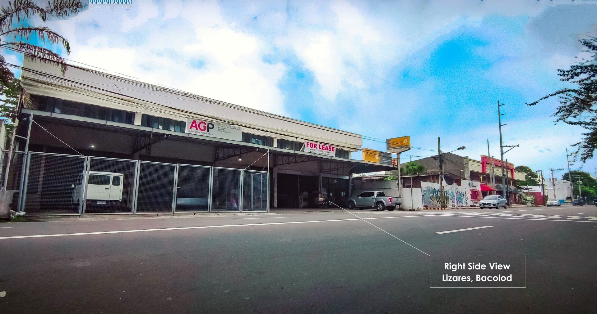 A large building is sitting on the side of a road.