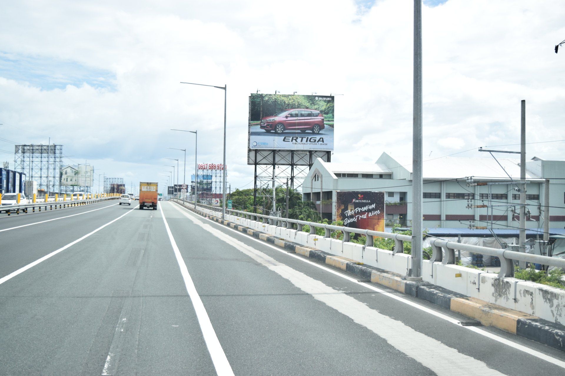 A highway with a large billboard on the side of it