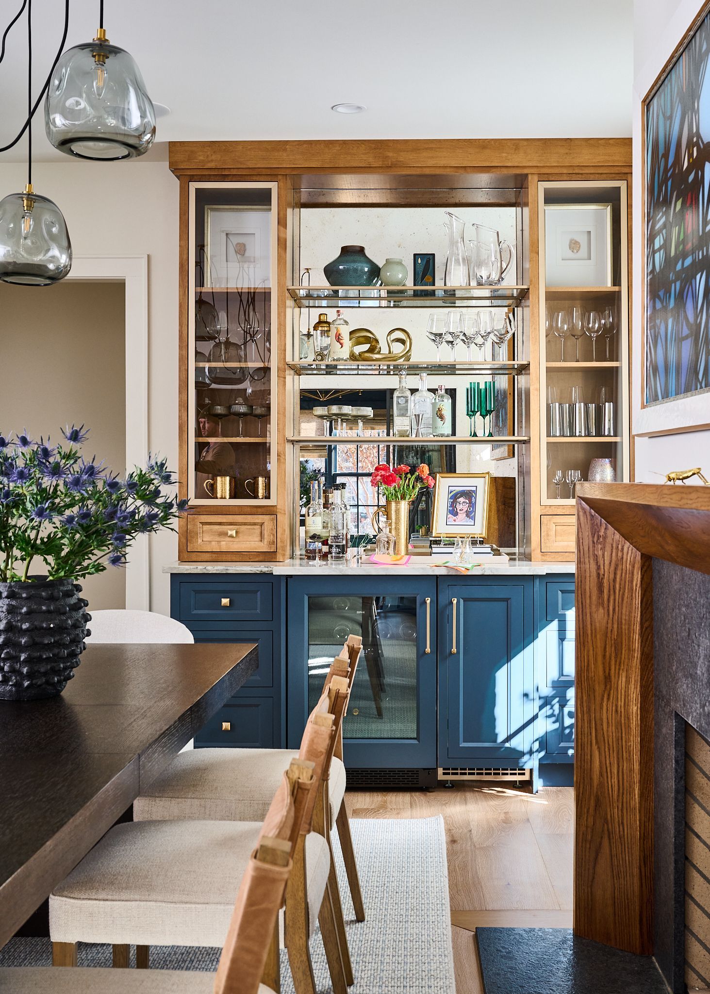 Dining room with blue bar, wooden shelves, and chairs.