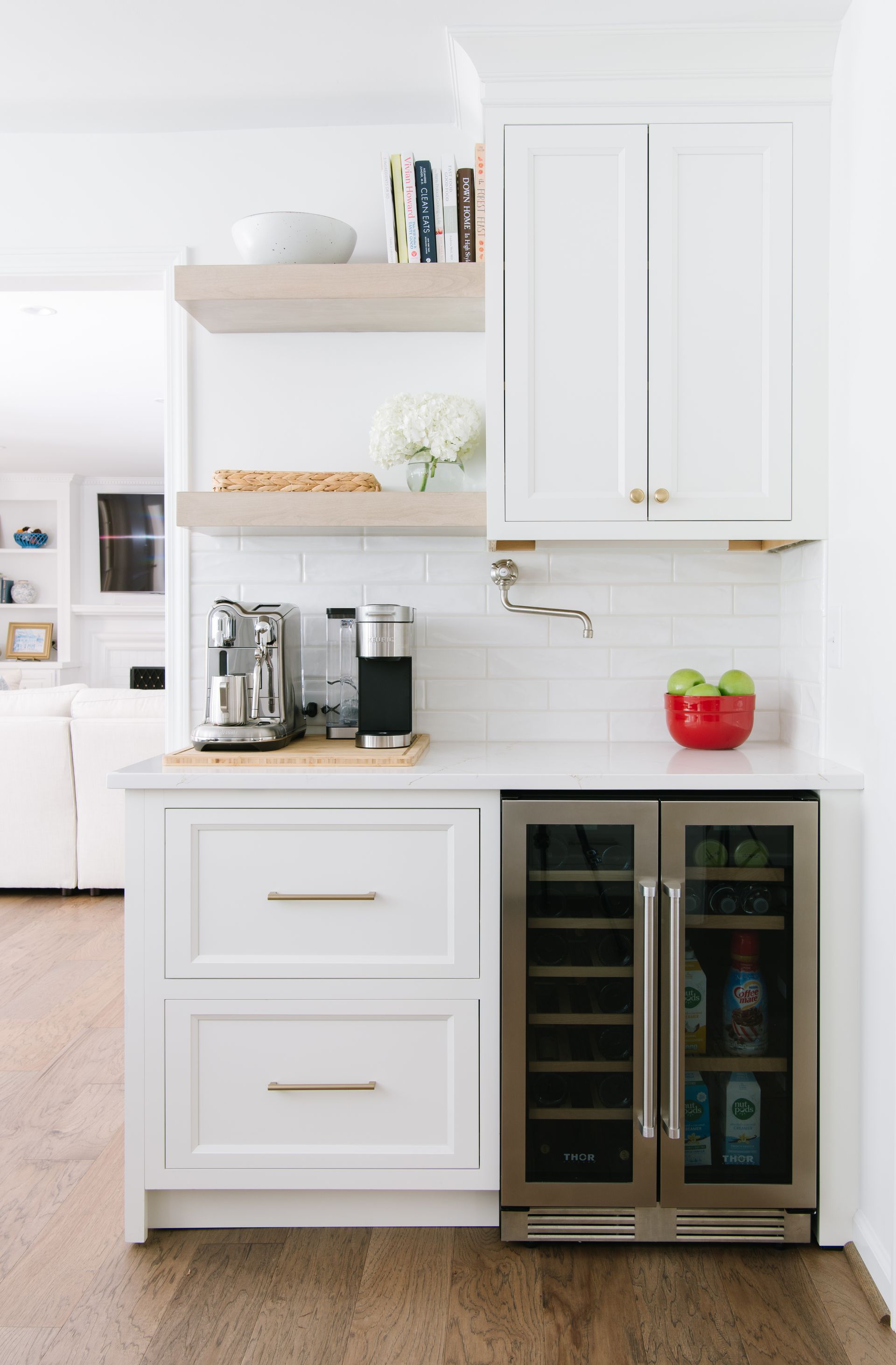 White built-in coffee/beverage station with open shelves, two-drawer cabinet, and a beverage refrigerator.