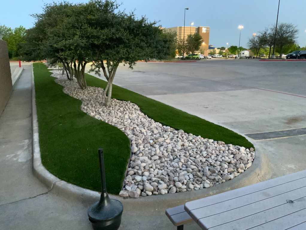 A picnic table is in the middle of a grassy area