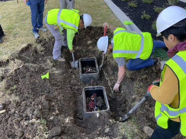 1st Impression Turf & Landscape crew are working on a sprinkler junction box. 