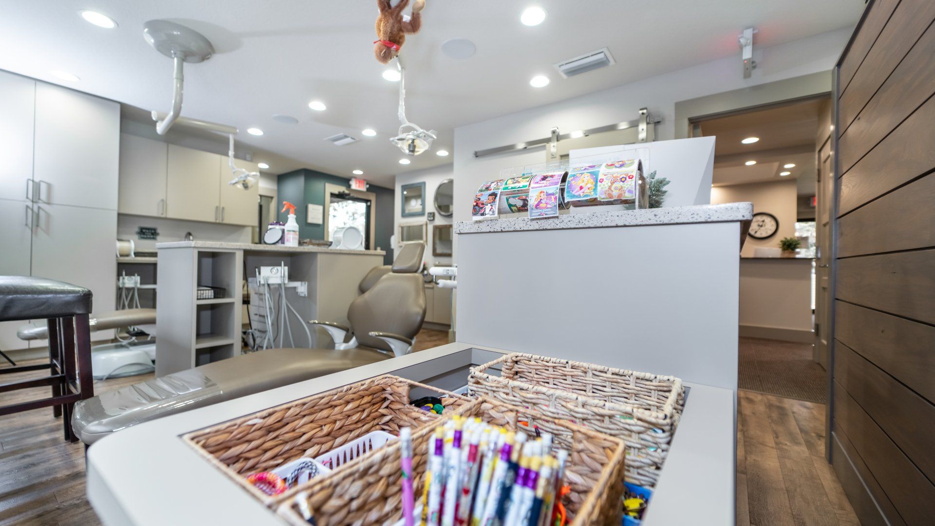 A dental office with a table with baskets of markers on it.