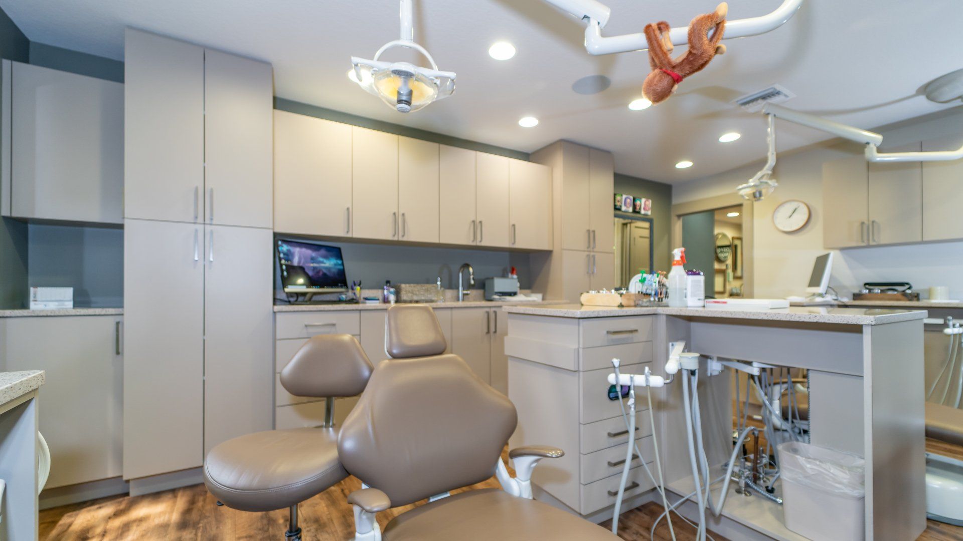 A dental office with a monkey hanging from the ceiling.