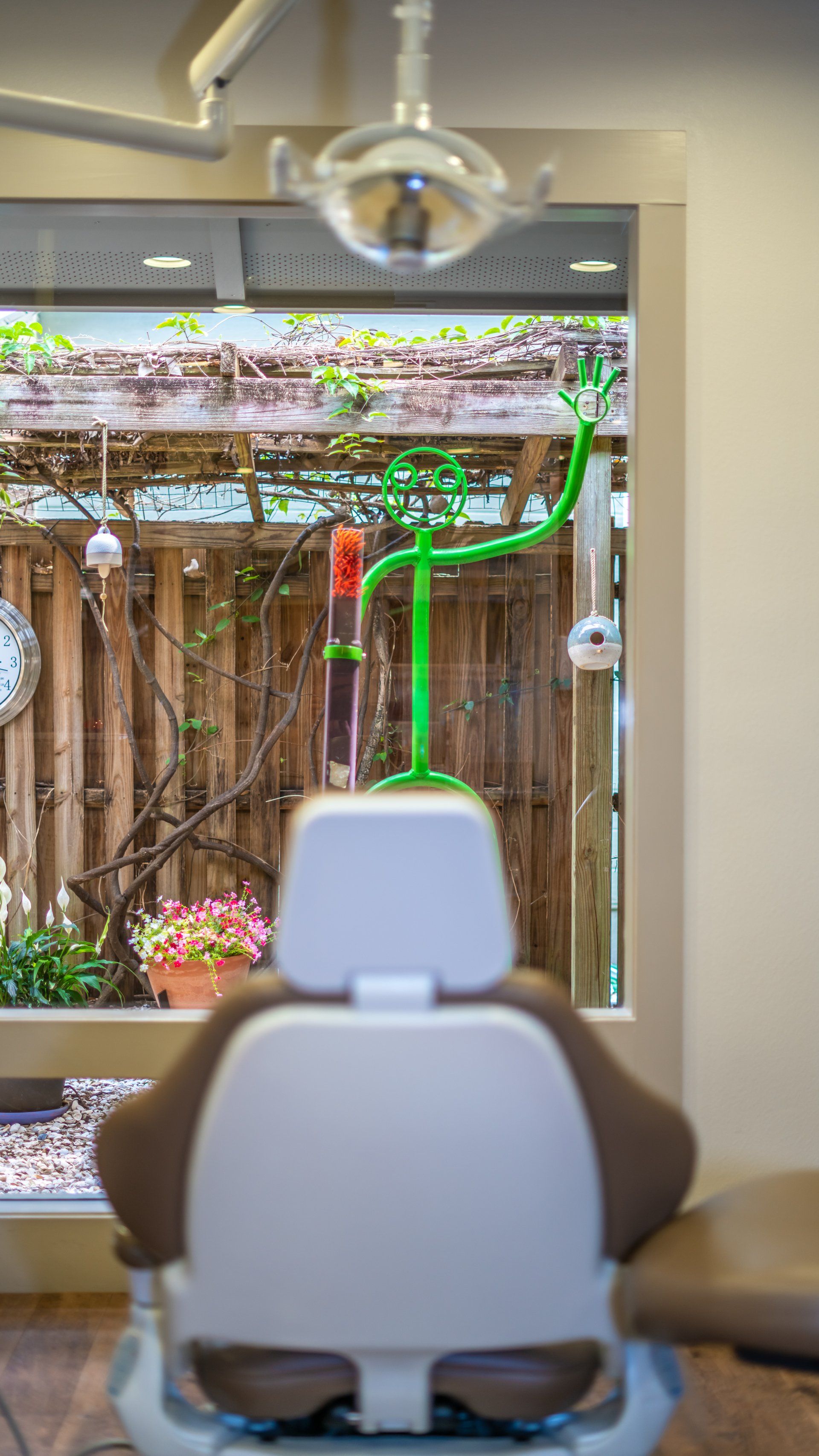 A dental chair is sitting in front of a window in a dental office.