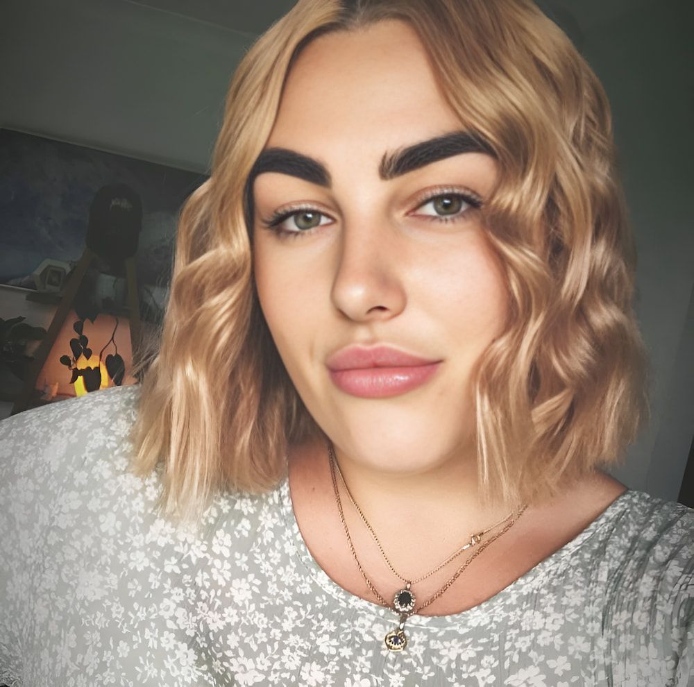 A Woman With Blonde Hair And A Necklace Looks At The Camera — Howard Street Hair Studio In Nambour, QLD