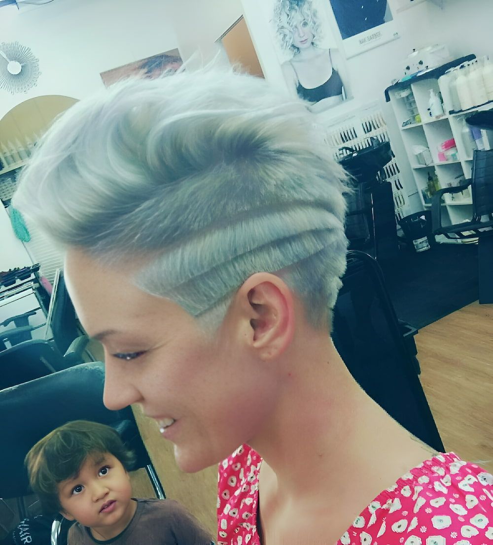 A Woman With Short Gray Hair Is Smiling In A Salon — Howard Street Hair Studio In Nambour, QLD