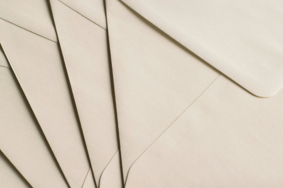 Overlapping beige envelopes, with shadows indicating depth.