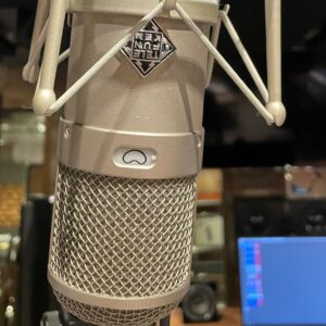 Telefunken studio condenser microphone suspended in a shock mount with a cardioid pattern icon visible.