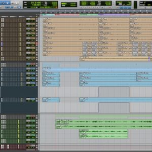 A digital audio workstation project screen showing tracks in tan, blue, and green with a multi-track audio editing timeline.