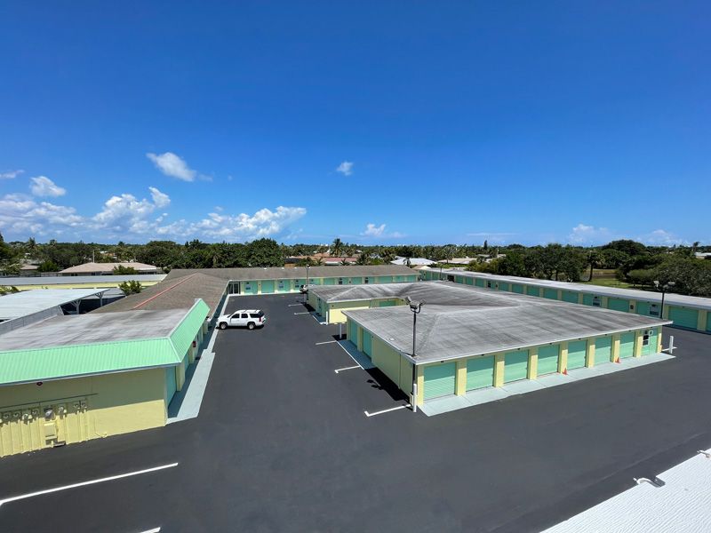 Modern building with wood and glass facade, blue sky.