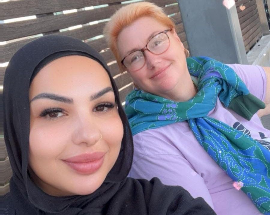 A man with a mustache is posing for a picture with a woman