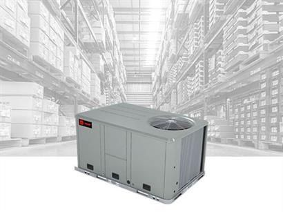 Gray rooftop HVAC unit in a warehouse setting.