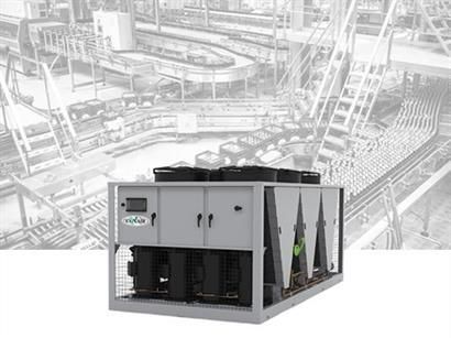 Gray industrial chiller unit in a factory setting.